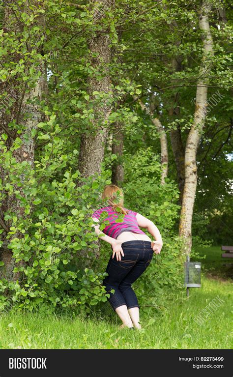 female peeing outdoors